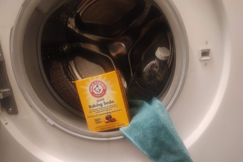 The Complete Laundry Guide | No More Laundromats Cleaning tools beside a washing machine