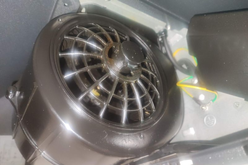 How to Clean a Range Hood Filter (Degrease in Minutes) Close-up of greasy range hood interior and filter showing heavy grease buildup