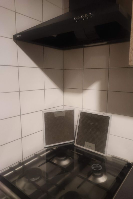 How to Clean a Range Hood Filter (Degrease in Minutes) Range hood filters removed from the hood, showing grease buildup on the mesh