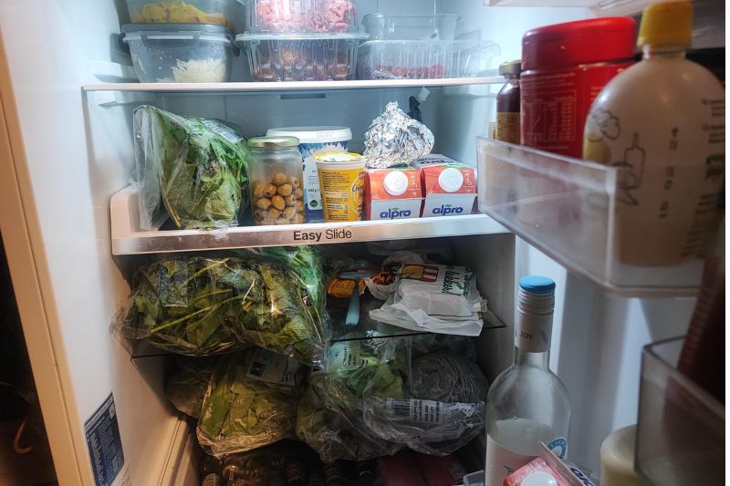 How to Deep Clean Your Kitchen: Full Sequence (2026) Inside of a filled refrigerator.
