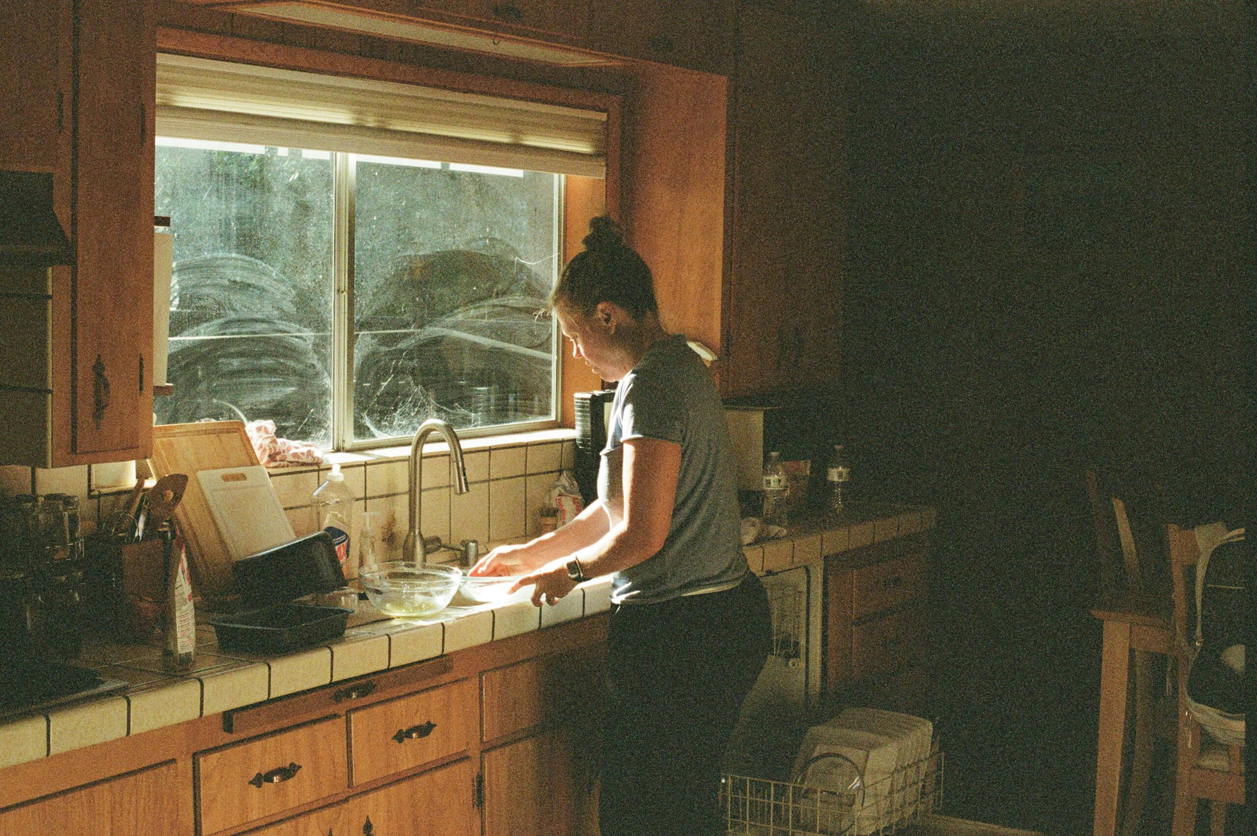 How to Deep Clean Your Kitchen: Full Sequence (2026) Person doing the dishes in a filthy kitchen=